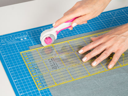 A real life view of a quilting rulers used in combination with the Rotary cutter on a cutting mat.